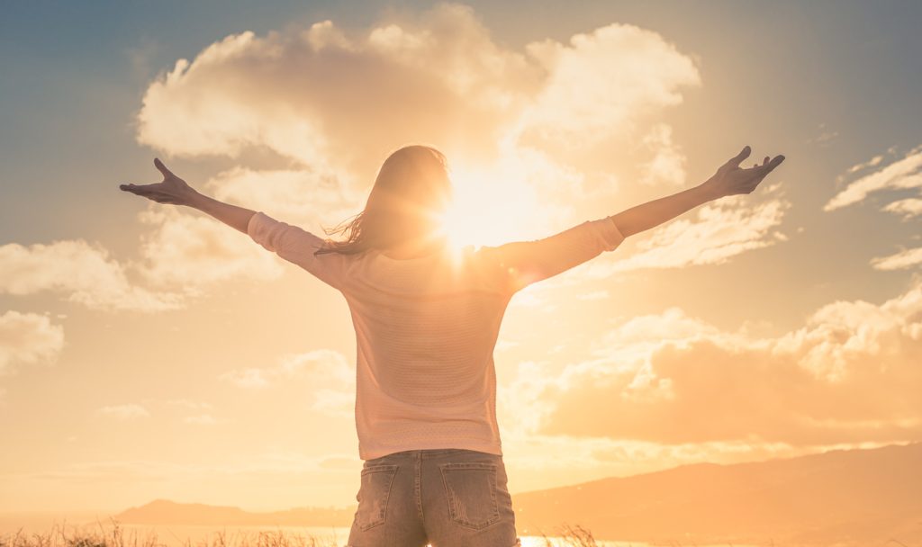 Navigating the Gender Recognition Certificate Process: A Complete Guide 8 Person embracing sunlight with open arms – symbol of legal gender recognition and personal freedom through Gender Recognition Certificate services by NotaryPublic24.com