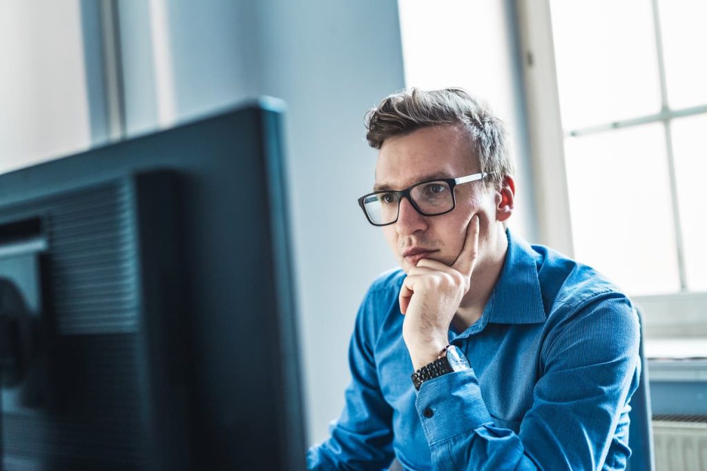 Everything You Need to Know About an Incumbency Certificate 3 Focused man researching incumbency certificates online. Learn what an incumbency certificate is, when it’s needed, and how to get it notarized or Apostilled with NotaryPublic24.