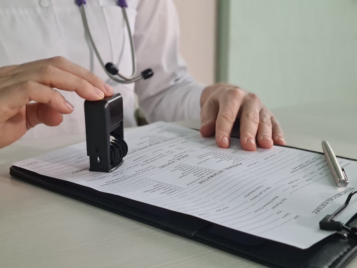 The Medical Report: Your Essential Guide for International Use and Immigration 1 Doctor stamping a medical report – essential for immigration, visa applications, and international use. Learn how to get your medical report notarized with NotaryPublic24.